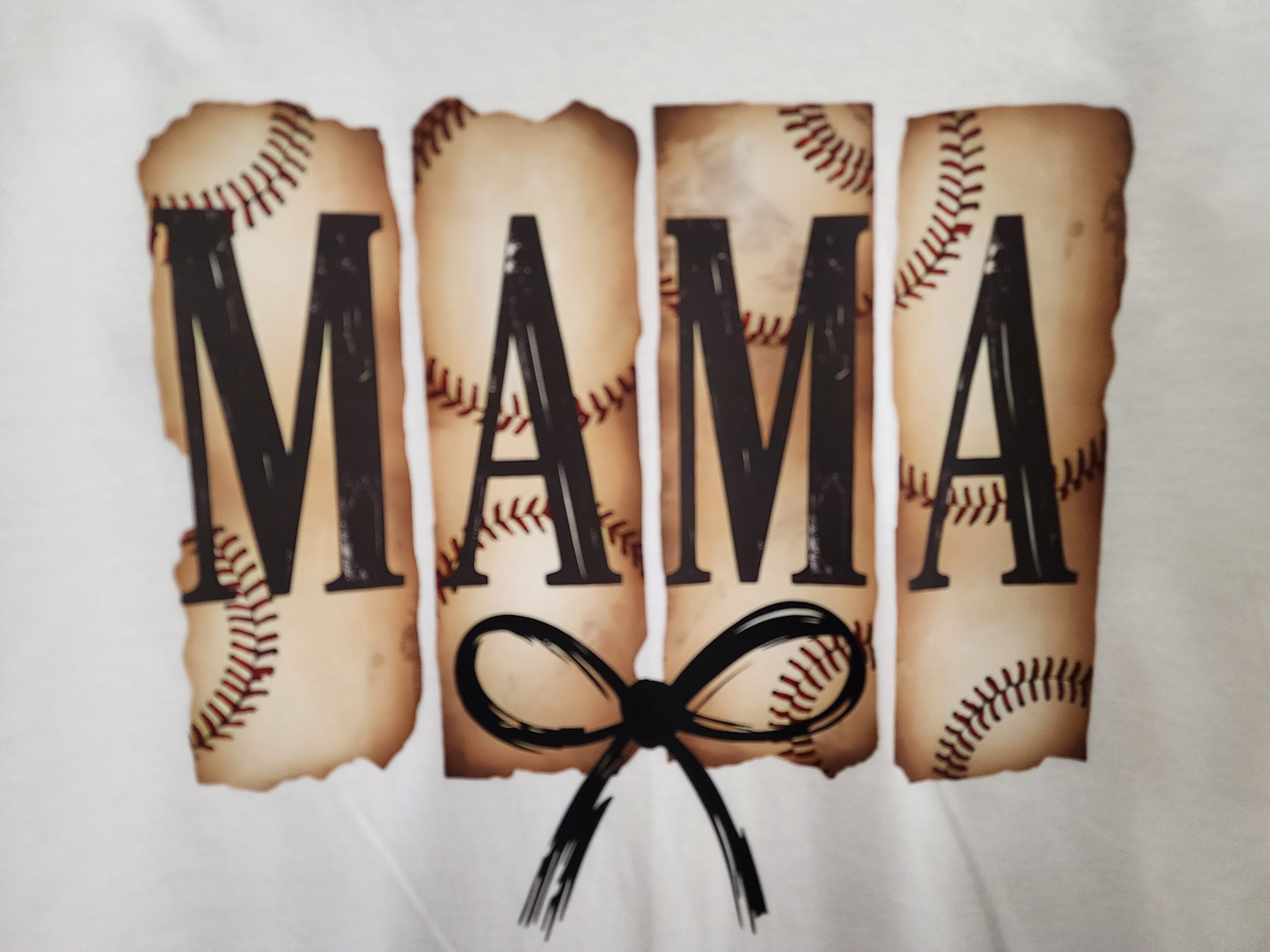 Baseball Mama with a Bow DTF print close-up - distressed baseball panels with black bow