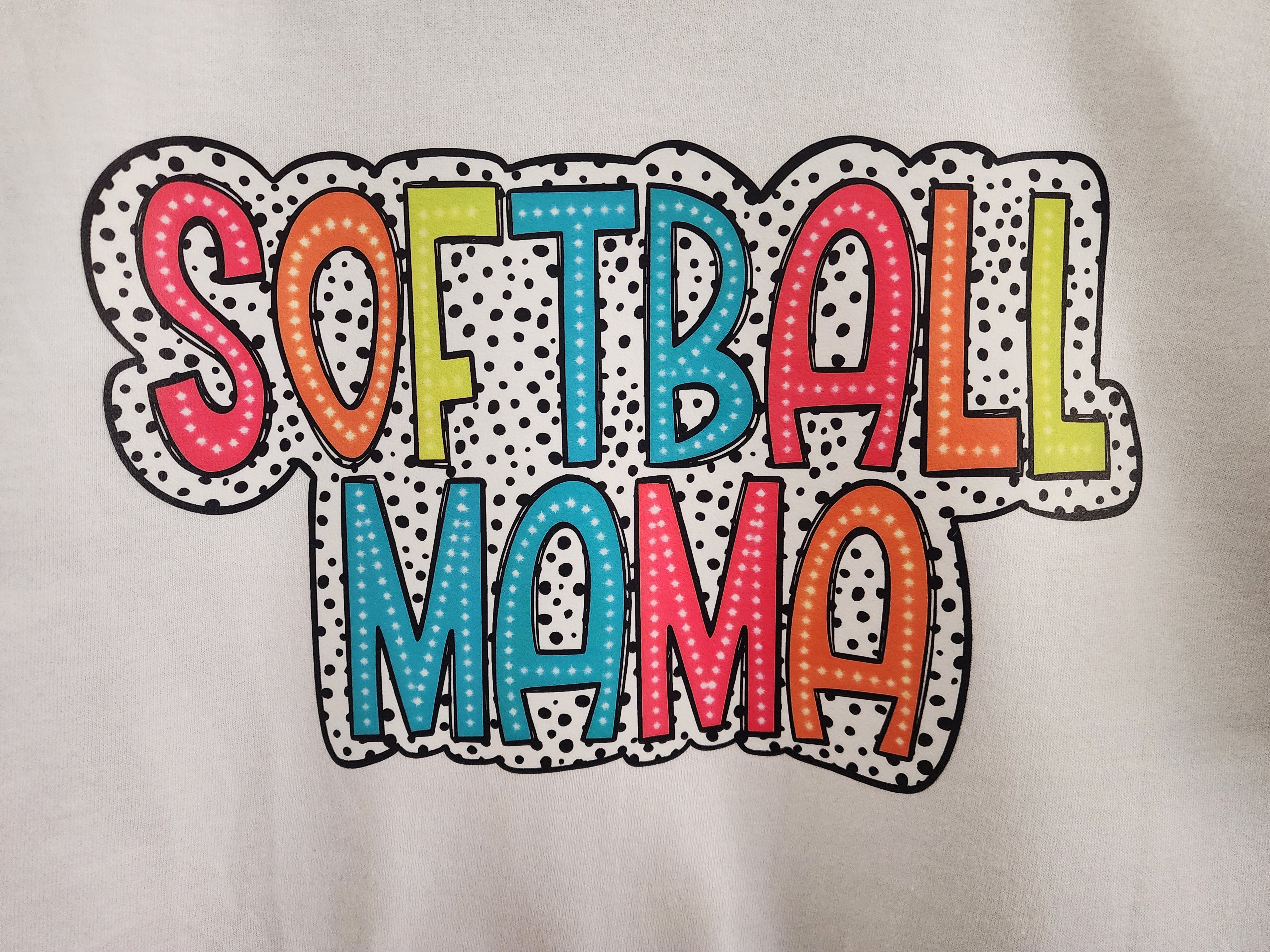 Softball Mama colorful dotted DTF print close-up - multicolor letters on dalmatian dot background
