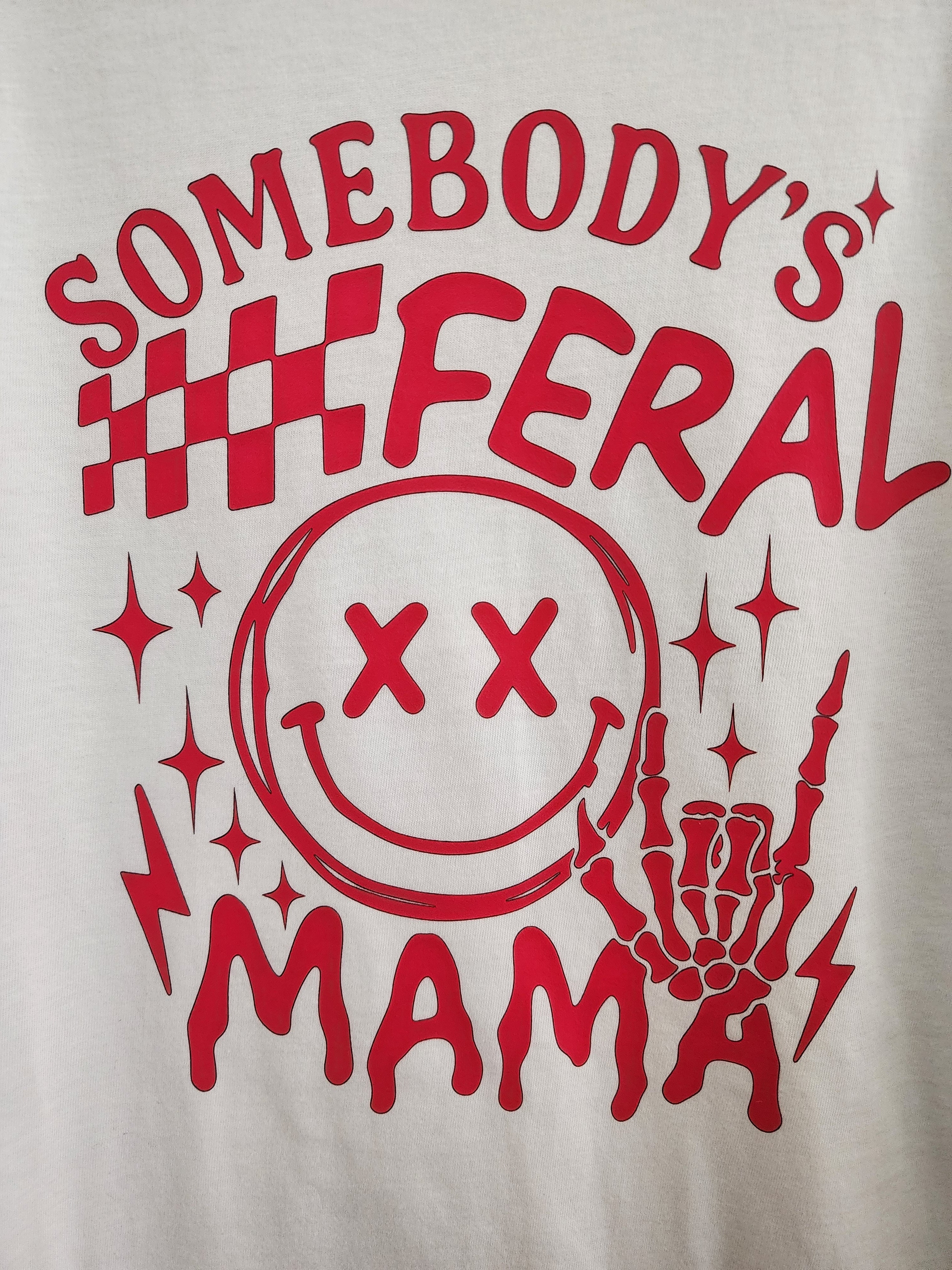 Somebody's Feral Mama DTF print close-up - red checkered flags, XX smiley and skeleton hand